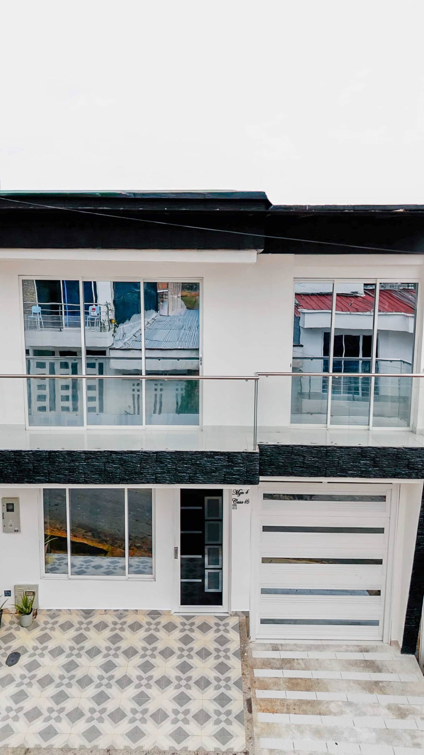 Fachada principal moderna de dos pisos de la casa de lujo en venta en Portal del Mirador.